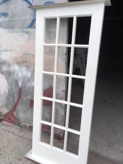 Fifteen-pane glazed timber door leaf finished in white, ready for fitting